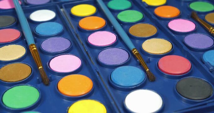 Palette of vibrant watercolor paints ready for artistic painting sessions. Watercolor paints in various colors for painting projects. Palette of colours