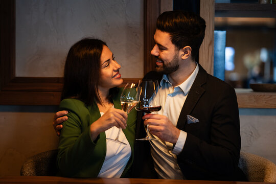 Couple celebrating anniversary with wine in a restaurant