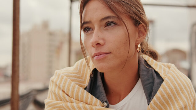 Thoughtful Young Woman In City Portrait