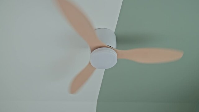 Ceiling fan spins quickly and then slows down until it stops. Concept of indoor ventilation, air circulation and home climate control