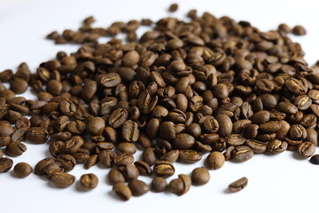 Fototapeta premium Gourmet Civet coffee beans scattered on white background, selective focus with bokeh.