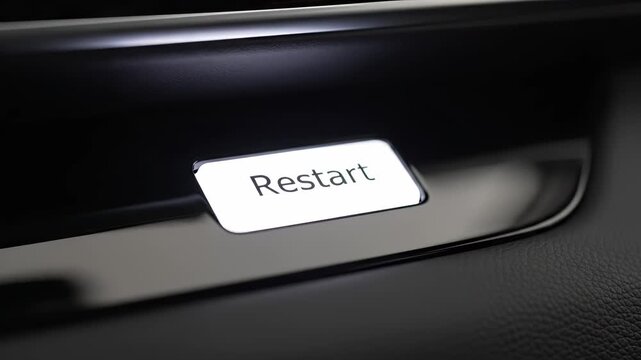 Close-up of an illuminated 'Restart' button on a dark, modern panel, symbolizing a fresh start concept and system recovery solution