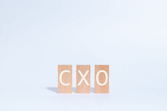 Eye-catching image of CXO text on wood blocks. The word stands for Chief user eXperience Officer.