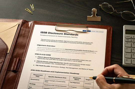 Professional visualization of ISSB Disclosure Standards on mock with clips, calculator. Financial and economic strategic background.