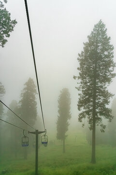 Ski lift in the clouds and fog on a summer day in the Santa Catalina Mountains near Tucson Arizona