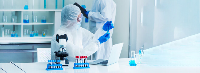 Banner Two asian scientist team reserch chemistry science tube experiment biotech antibody laboratory Cultivate Vaccine against virus. Two Scientist consulting Chemistry Laboratory with copy space