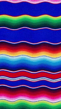 A traditional, colorful Mexican sarape with wavy patterns. Abstract background.