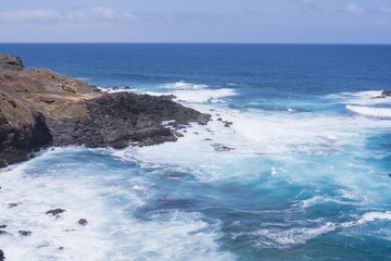 Obraz premium Coastal view of Tenerife near Garachico. Ocean waves hitting volcanic rocks