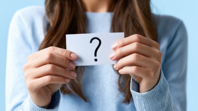 Woman holding card with question mark. Concept of inquiry, doubt, curiosity and decision making. Minimalist visual for questions and answers