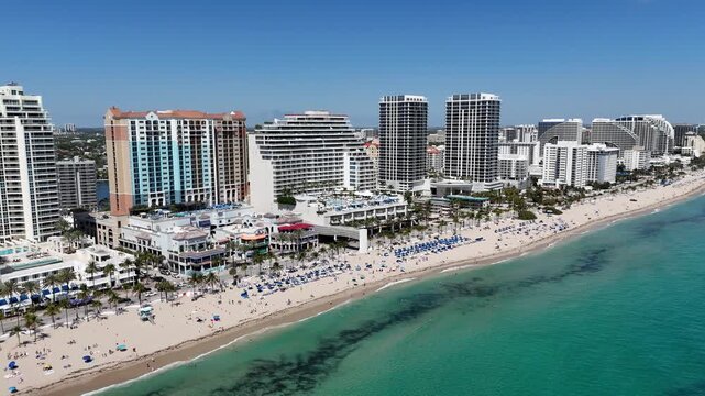 Tourists enjoying a sunny Ft Lauderdale Beach day near Las Olas Blvd in Broward County, Florida. 