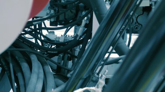 Industrial equipment with many hydraulic and pneumatic hoses that enable the operation of mechanisms. Closeup. Shot in motion