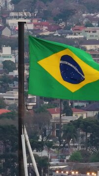 Brazil National Flag Flying High Above Curitiba City View in Brazil