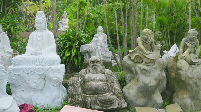 Various Buddha statues are displayed in a garden in Ngu Hanh Son, Da Nang, Vietnam. The statues represent different aspects of Buddhist teachings and are a place for contemplation.