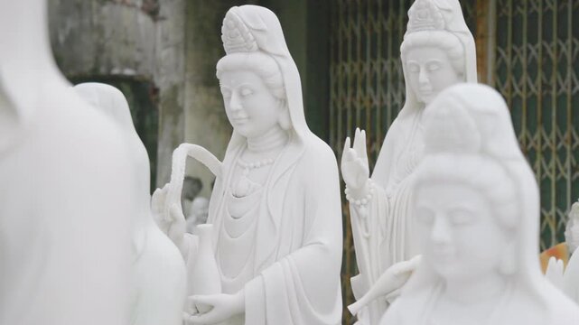 Close-up of a white marble Quan Yin statue in a temple in Ngu Hanh Son, Da Nang, Vietnam. The statue is a symbol of compassion and mercy, and is revered by Buddhists.