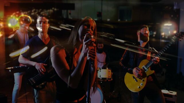 Lead singer stepping to mic and singing, opening riff starting, streaks pulsing, building climax