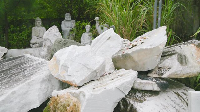Marble stones are piled up in a garden in Ngu Hanh Son, Da Nang, Vietnam, where sculptors create statues and other works of art from the locally sourced stone.