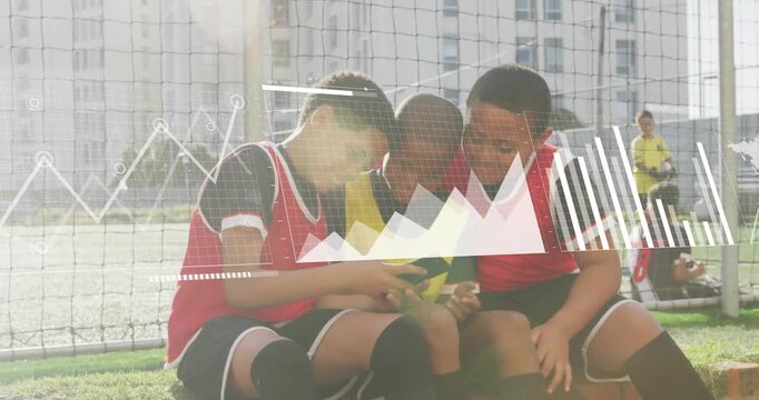 3 boys by goal net raising phone then huddling and analyzing sports charts overlaying phone screen