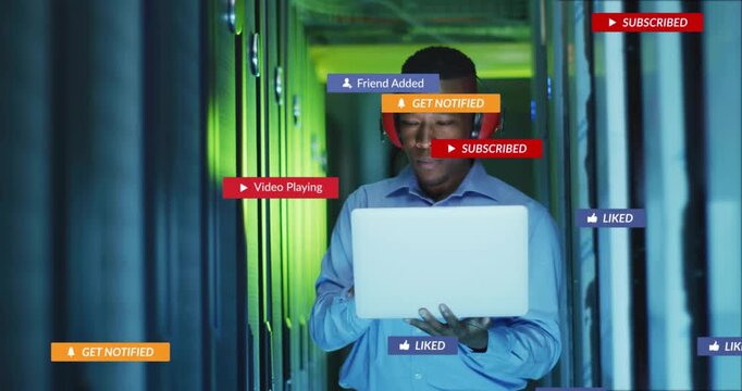 IT sysadmin holding laptop in rack aisle prompt spawning alerts on laptop, then clearing for review