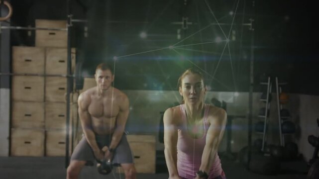 Woman and man swinging kettlebells, overhead lift driving hips, overlay tracking arcs for fitness