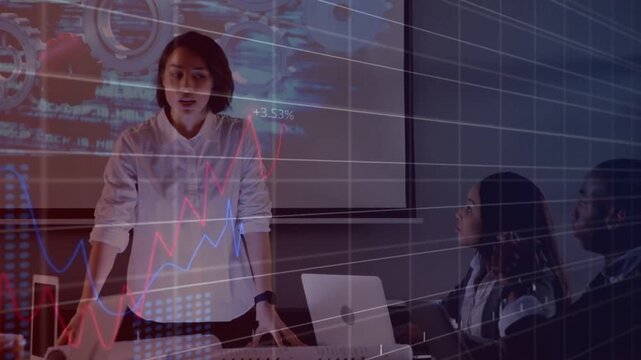 Presenter clicking remote gesturing, showing finance overlays on screen and laptops, earning claps