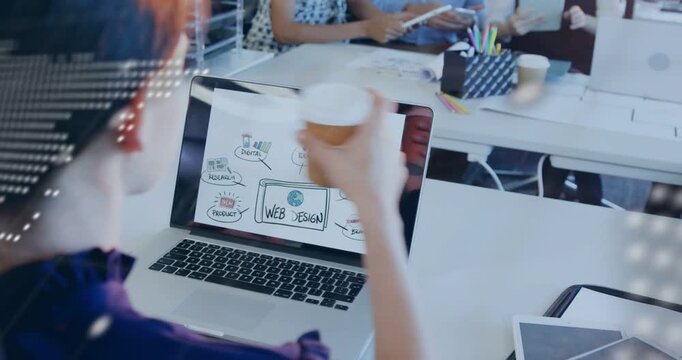 Pointing colleague woman holding coffee typing on laptop at open-plan office working on web design
