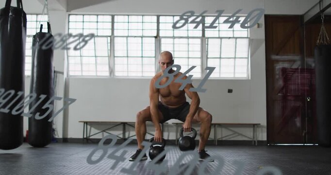 Man doing alternating kettlebell cleans from sumo squat in gym, building strength, numbers floating