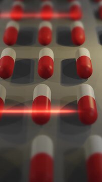  Red and White Drug Pills or Capsules being Produced in Lab - Vertical