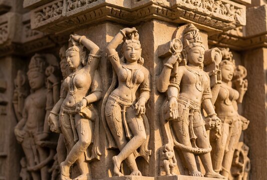 A close-up, highly textured photograph focused on the intricate and detailed sculptures carved into the walls of the Lakshmana Temple in Khajuraho, Madhya Pradesh, India. 
