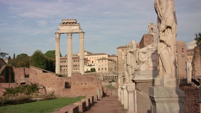 Ancient Roman Forum in Rome with standing columns and marble statues among historic ruins under soft daylight creating timeless archaeological landscape in Italian city