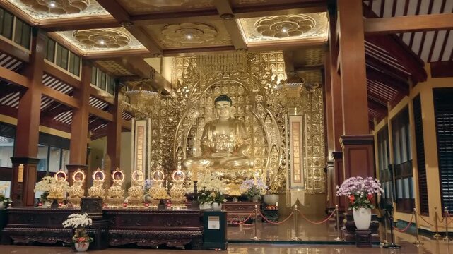 HO CHI MINH, VIETNAM - SEPTEMBER 20, 2024: Rich interior decoration of the Viet Nam Quoc Tu Pagoda (Vietnamese National Pagoda) with massive golden statue of The Buddha on the altar