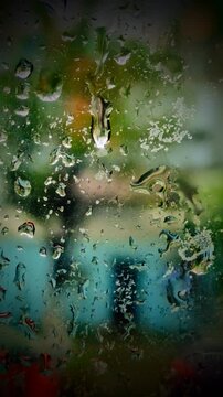 Background of raindrops reflected in the window of a house on a calm rainy day.Fondos de gotas de lluvia&nbsp; reflejadas en la ventana&nbsp; de una casa en un d&iacute;a lluvioso tranquilo.(180)