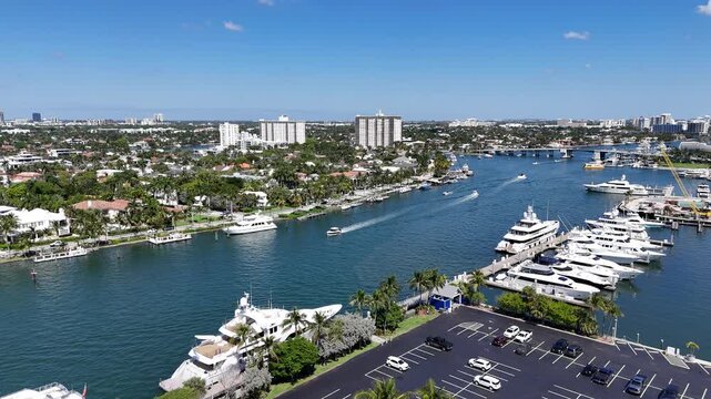 Still shot of boats cruising in the intracoastal waterway with large yachts docked at port in Fort Lauderdale in Broward County, Florida.