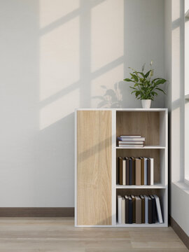Wooden sideboard bookshelf with potted plant on parquet floor at white wall corner in a modern room
