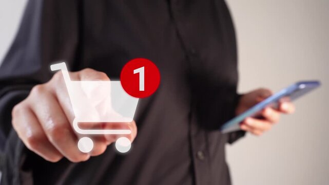 A businesswoman holding a smartphone while pointing forward at a shopping cart animation with a notification of the number of items added.
