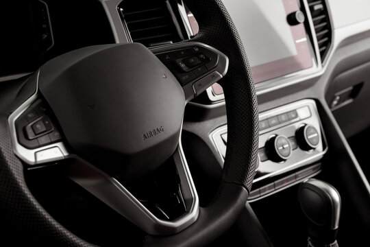 Steering wheel of a new vehicle close up, interior cockpit, electric buttons