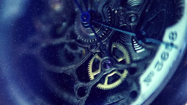Beautiful internal structure of a skeleton wristwatch where shiny gears, wheels and hands move with bright bokeh. View through sparkling particles. Closeup. Macro. Shallow depth of field