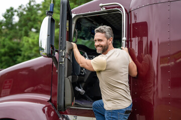 Naklejka premium Hispanic man get into truck. Semi trucks vehicle. Man owner truck driver. Transportation industry. Man driver near lorry truck. Truck driver. Trucking owner. Transportation vehicle