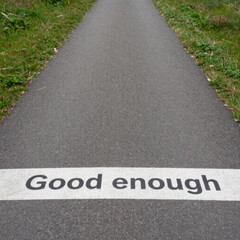 Obraz premium Road marked good enough indicating lowered standards acceptance and compromise within governance policy decisions and political accountability