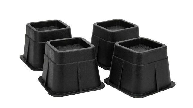 Four black plastic bed risers for acid reflux relief PNG