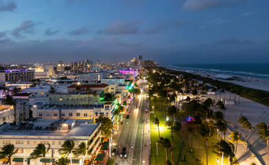 Obraz premium Top view of South Miami with Ocean Drive at evening. Aerial view of Miami with Ocean Drive at night. Panoramic Miami evening coastline with Ocean Drive. Miami shoreline on Ocean Drive.