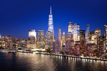 Obraz premium NYC panoramic view of the Lower Manhattan skyline. New York City aerial skyline panorama. New York urban landscape. NYC night cityscape with Manhattan skyline. New York City wide panoramic skyline.