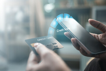 Credit score monitoring on smartphone with credit card, representing financial health, loan...