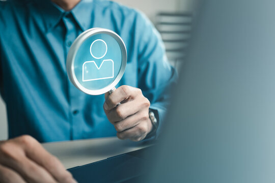 HR professional using magnifying glass to evaluate candidate profile, representing recruitment, talent search, hiring process and employee selection.