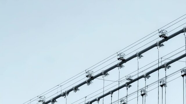 Suspension bridge main cables and vertical suspender ropes forming an intricate network, highlighting modern engineering marvels and reliable infrastructure supporting transportation