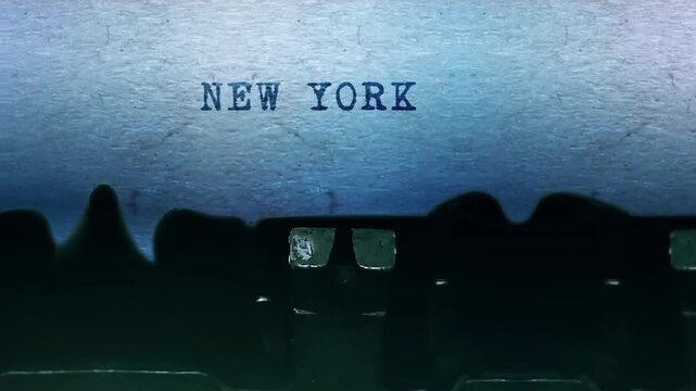 A close-up video of a typewriter printing the words New York on a sheet of paper