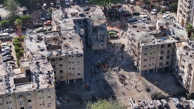 Aerial view Holon Iranian missile strike destruction Israel

Drone footage showing rescue teams at missile impact site in Holon residential area Israel June 14 2025
