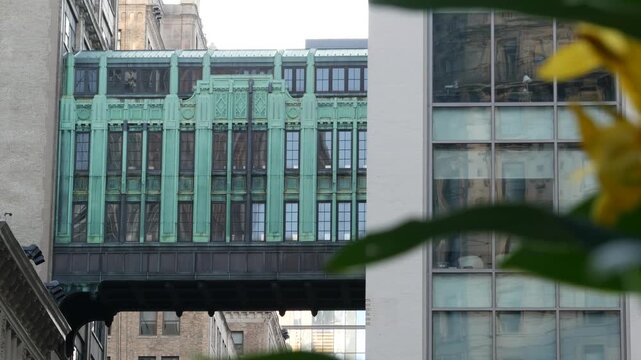 New York City Gimbels bridge, Manhattan Midtown, United States of America. Skybridge on Broadway, Herald Square, USA. Gimbels traverse on 6 avenue. Historic elevated walkway 1925, copper green patina.