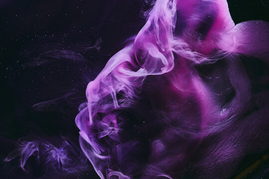 Abstract colorful purple pink black background. Moving flow of paints, fluid liquid art, space sky
