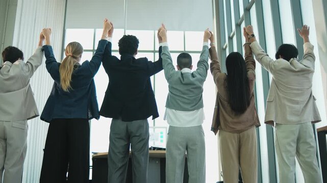 Multiracial Businessperson united commitment partnership, hand raises together, synergy and harmony business company worker with solidarity goal motivation, group of professional teamwork in firm.