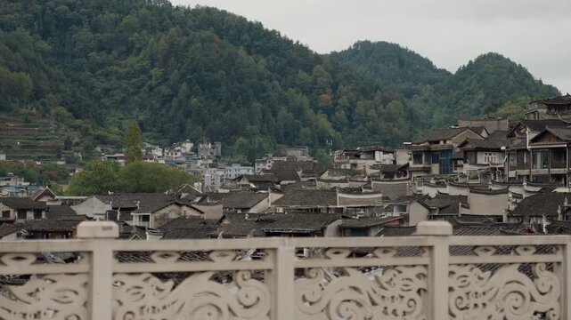 Picturesque hillside village with traditional houses. Serene mountain hamlet featuring tiled roofs and cultural charm. Peaceful hillside community with historic architecture and tranquil ambiance